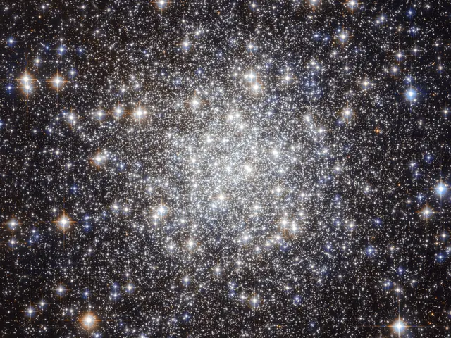 Large galaxy that's globular in shape, the closer to the center you get the brighter and whiter the image due to the amount of stars. Stars are everywhere in this image, of all sorts of colors.