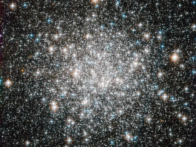 A bright cluster of white stars, more concentrated near the center.