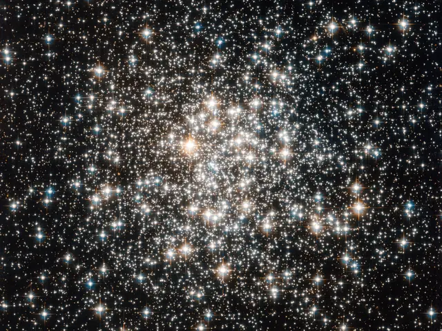 A bright cluster of white and yellow stars against black space.